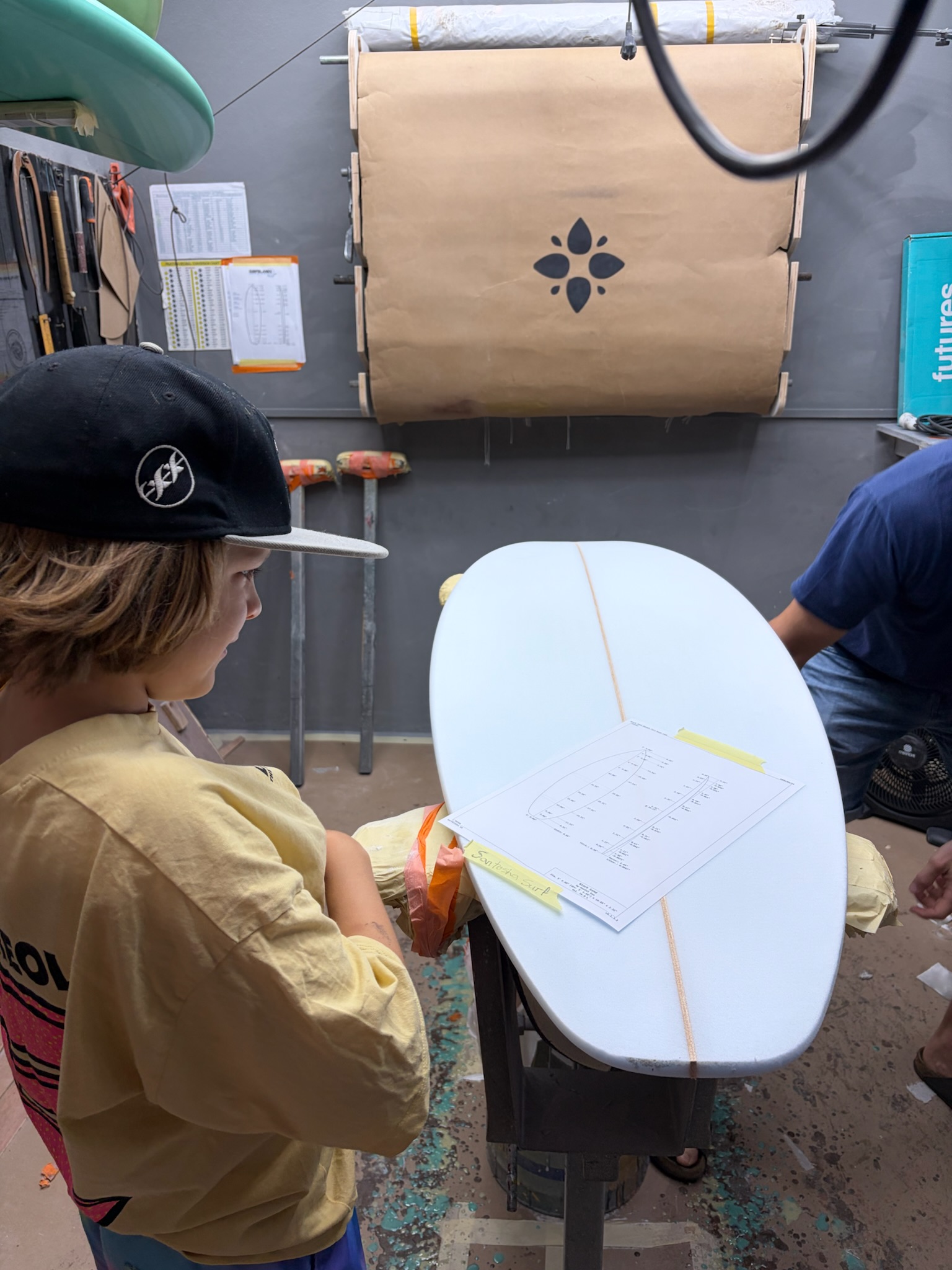 Noah checking the spec sheet taped to the deck of the blank
