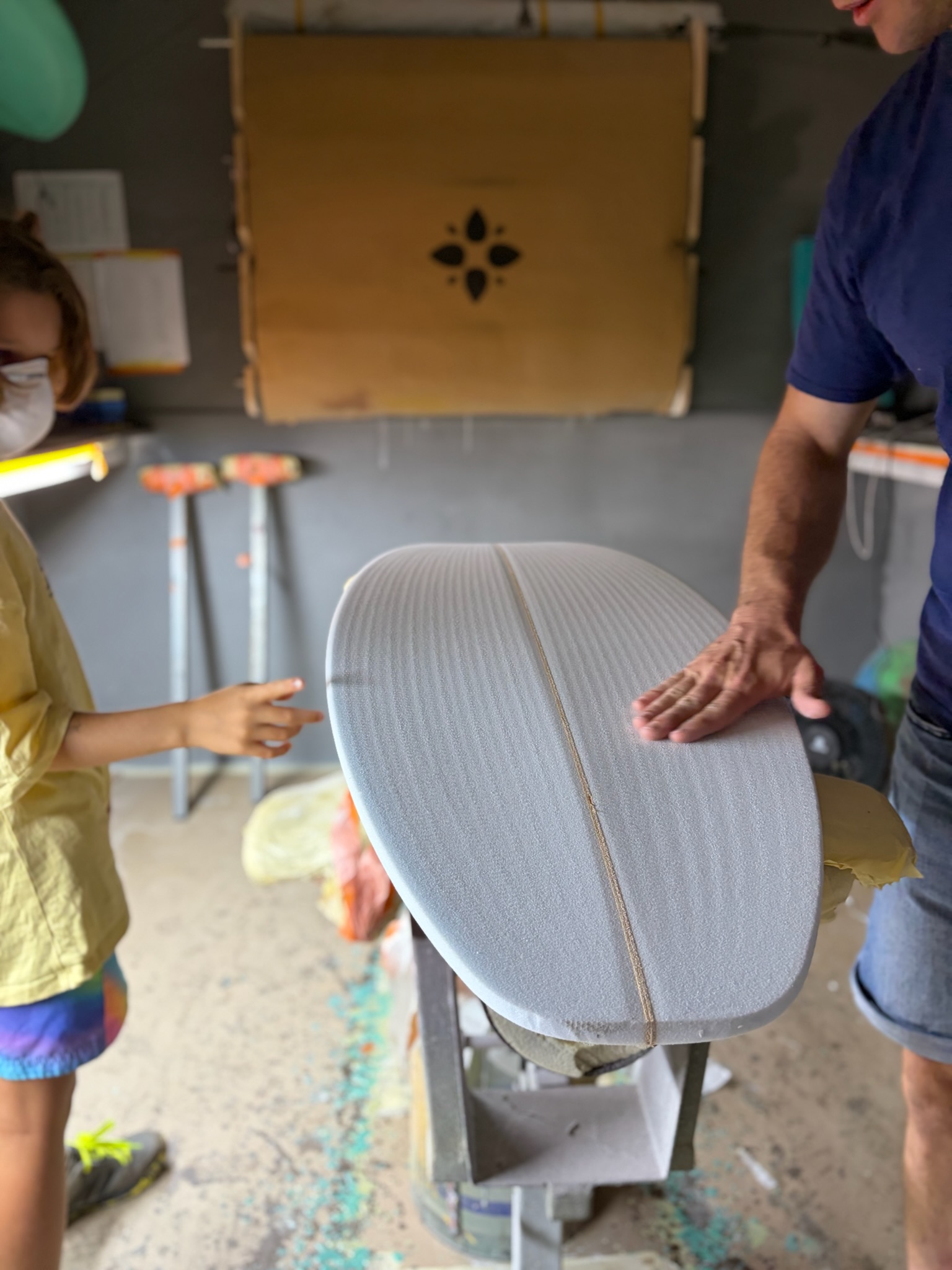 Noah behind the foam, board in the foreground