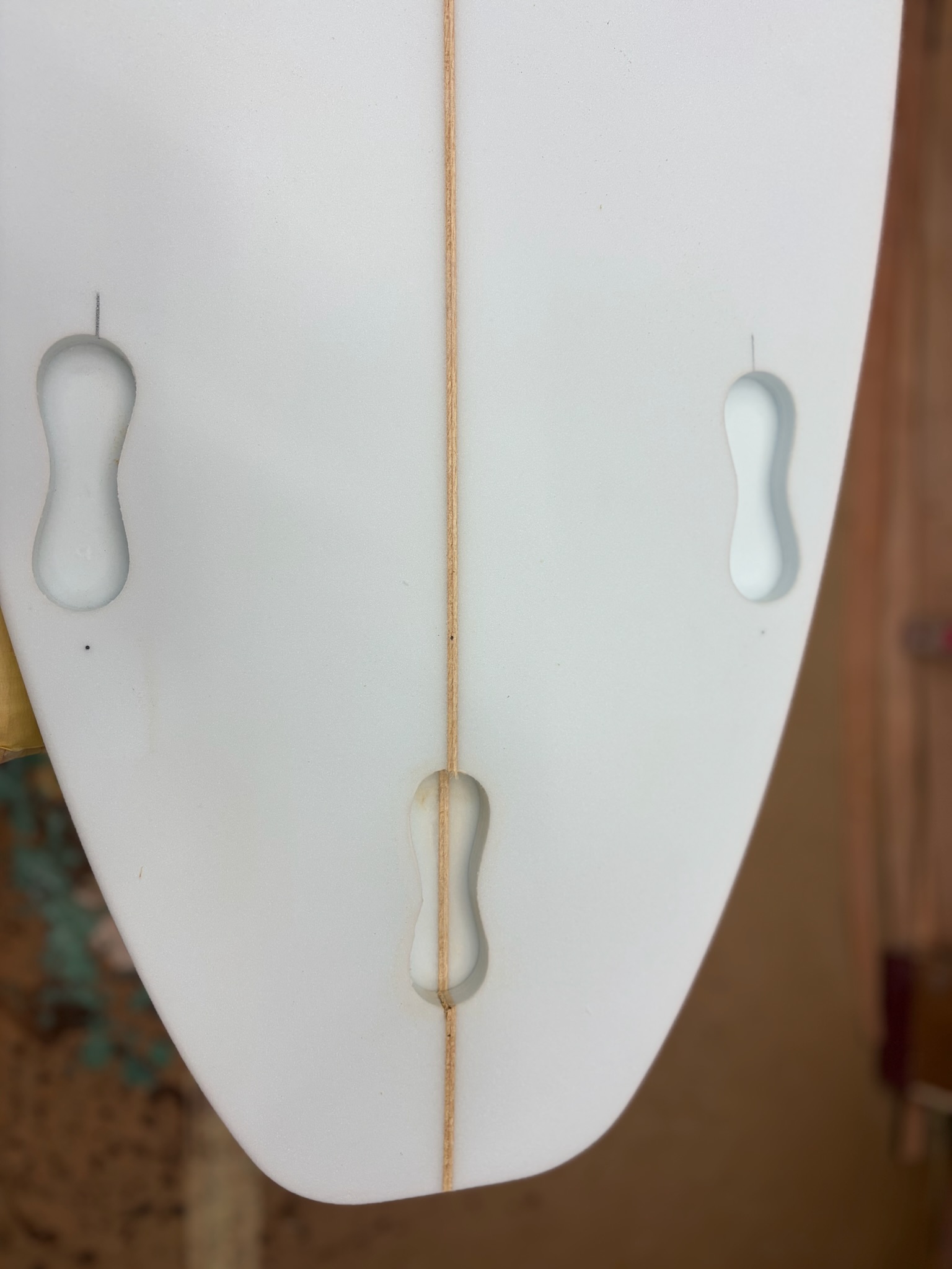 Fin boxes set into the white glassed bottom near the tail