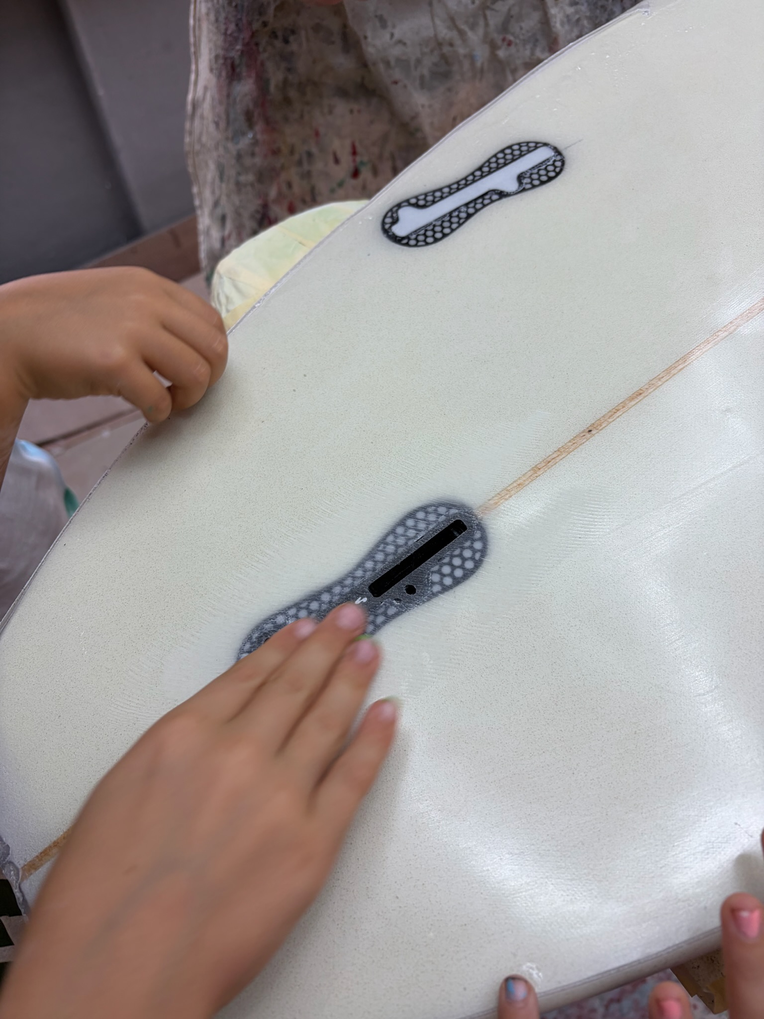 Close-up of a fin box, taped and set into the board