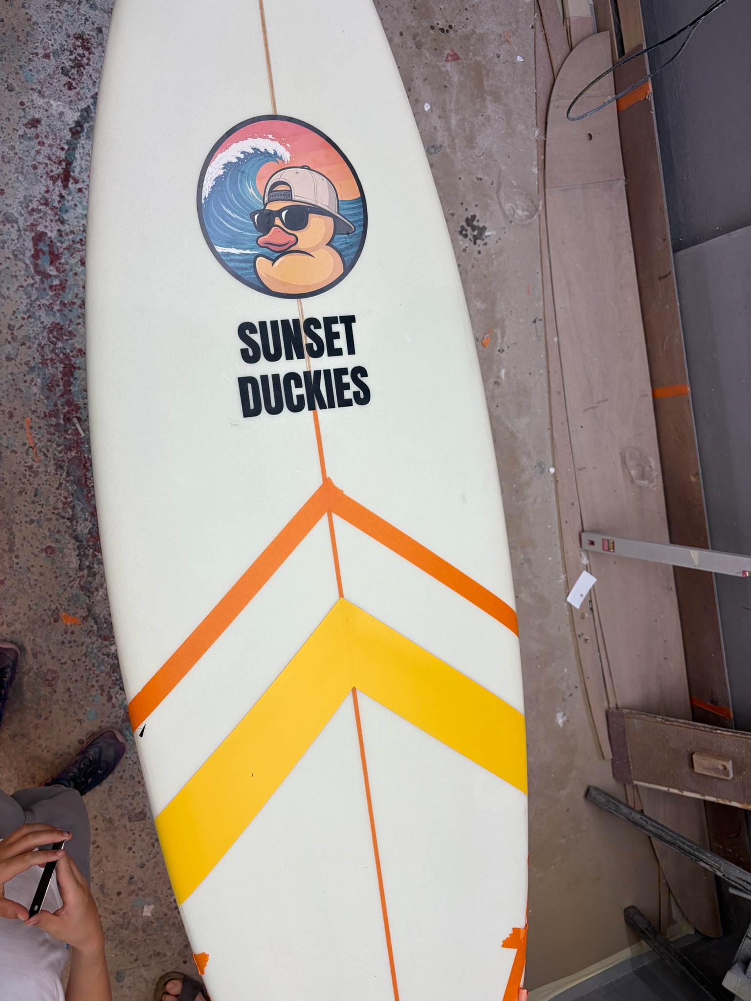 The finished board outdoors, duck logo and wordmark and chevron, clean