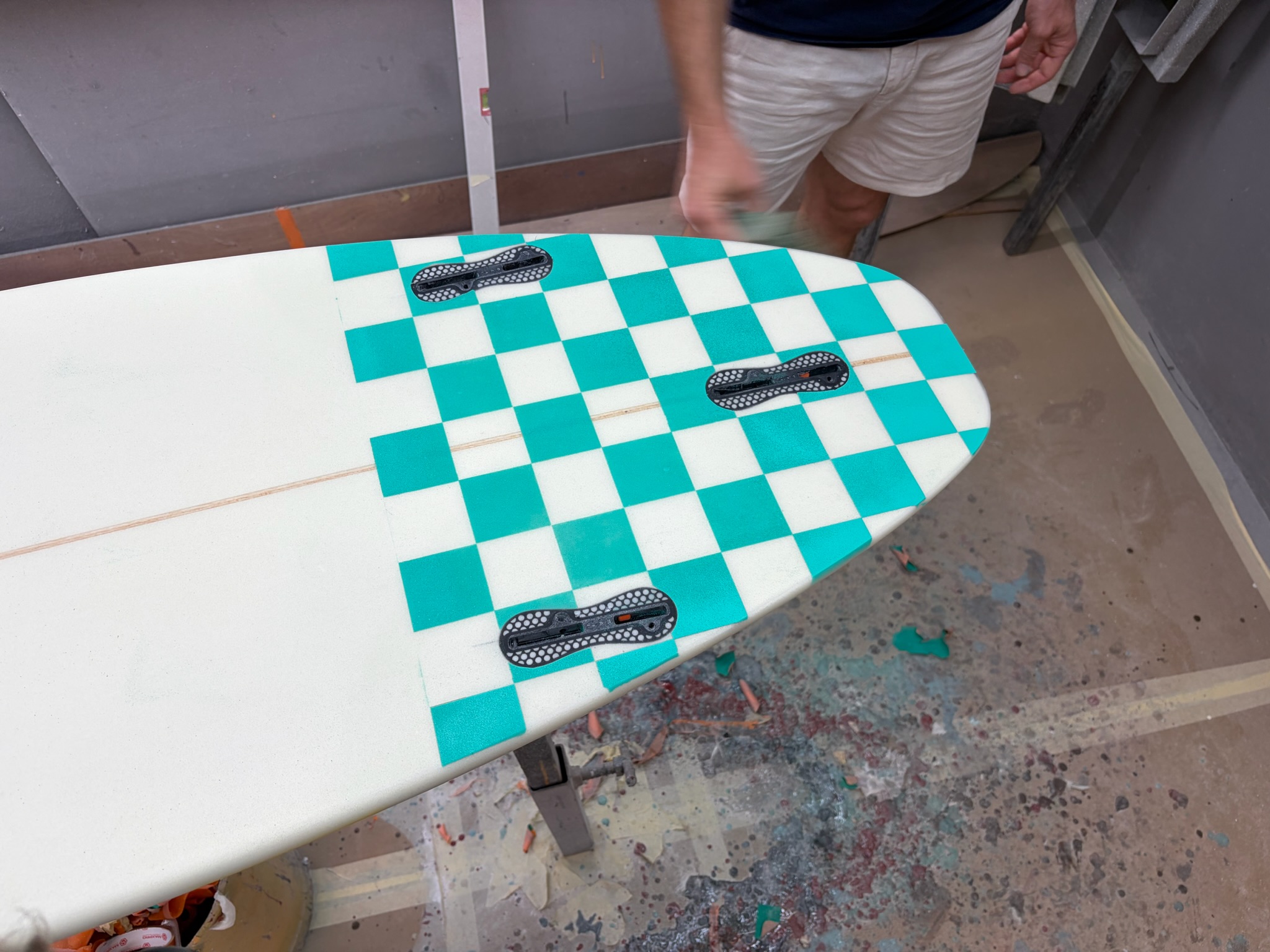Top-down view of the teal checkerboard tail with three fin boxes installed