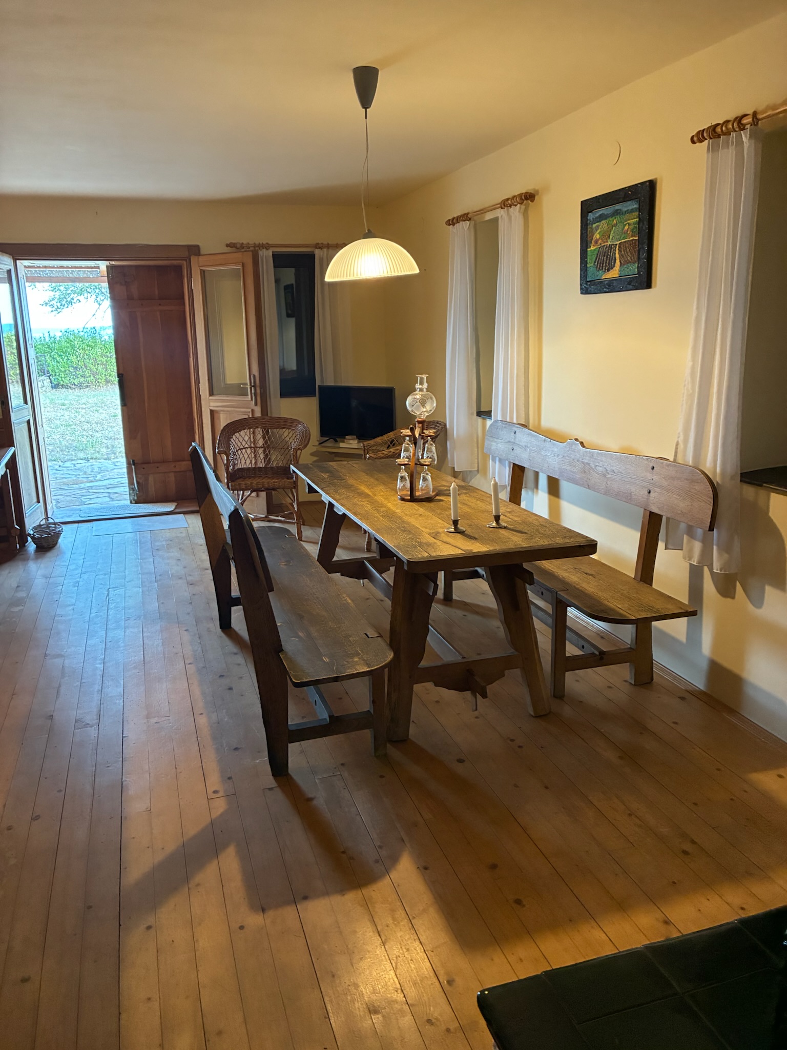 The dining area with rustic table and wooden floors