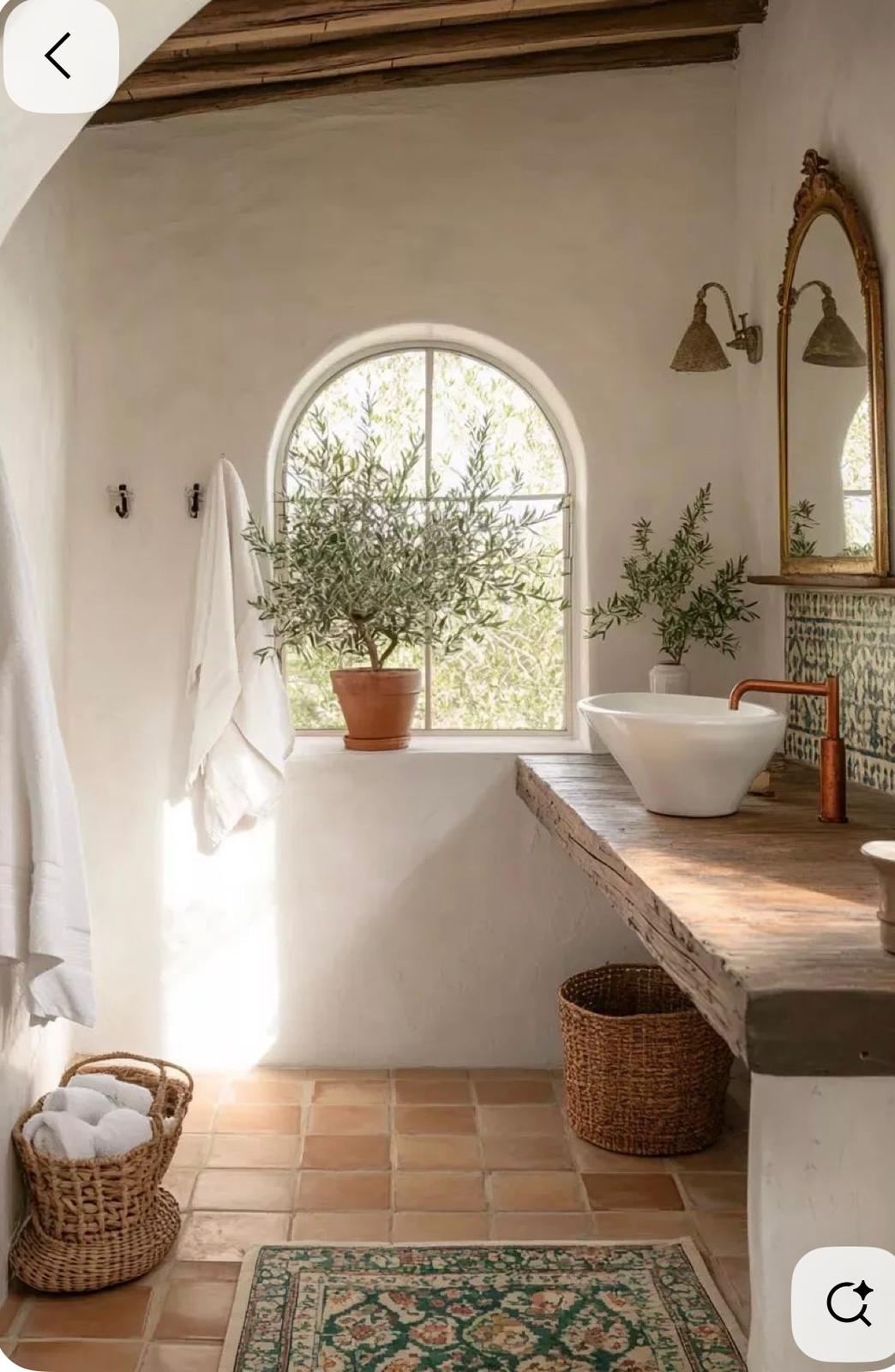 Mediterranean vanity with arched window and terracotta floor