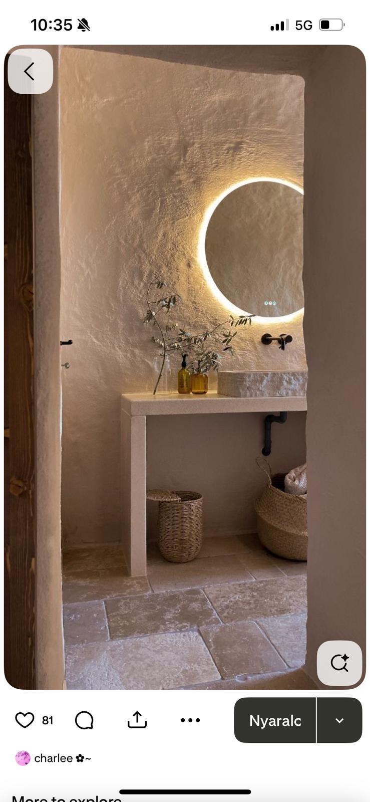 Plaster wall vanity with backlit round mirror