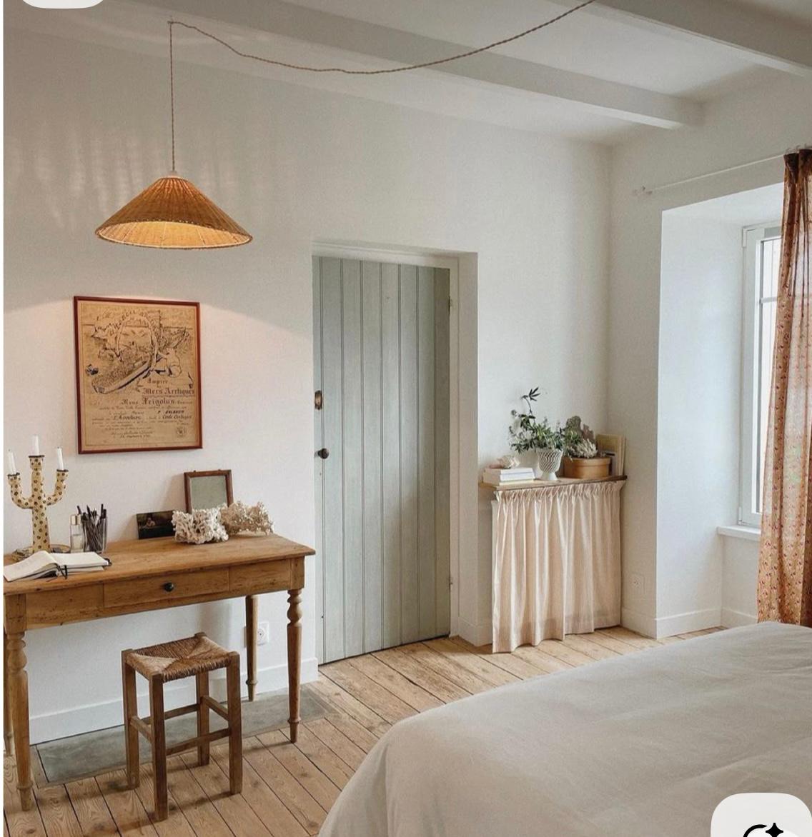 Cottage room with rattan pendant and sage green door