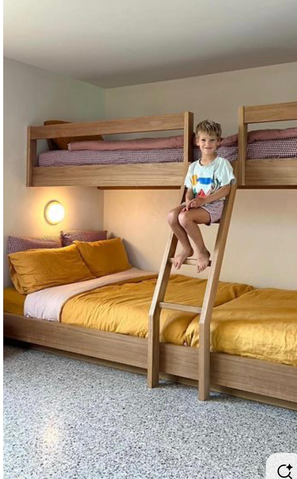Colourful triple bunk with ladder and wall lights