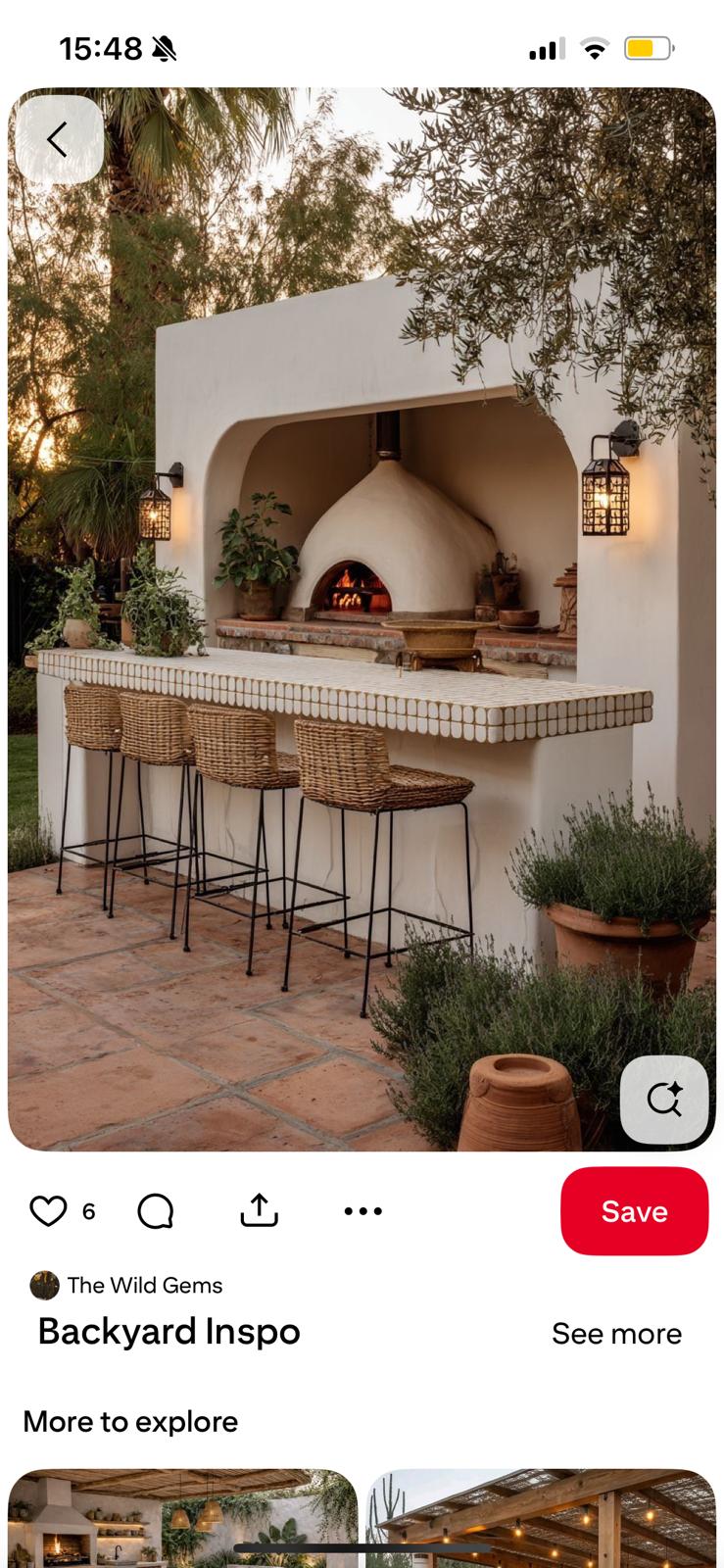 Plaster wood-fire oven with rattan bar stools