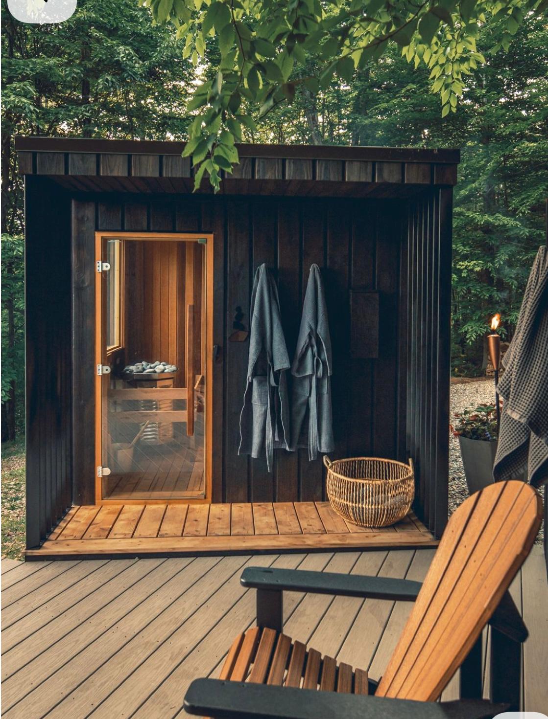 Wooden barrel hot tub in garden with string lights